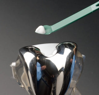 Heathrow Scientific OR1203 Plastic Curette, Whitney Sculps Knife with a green handle on a dark background