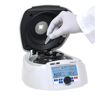 Oxford Benchmate C12V Microcentrifuge centrifuge with a hand wearing a glove holding a test tube