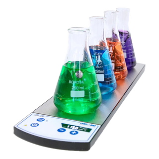 Borosil beakers with colored liquids on a Oxford Benchmate MS4 Magnetic Stirrer against a white background