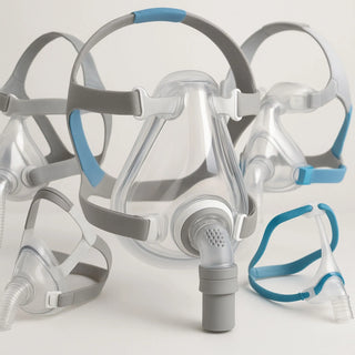 CPAP and BiPAP mask with tubing, humidifier, and headgear used for sleep apnea therapy at home
