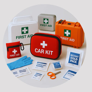 Portable and vehicle first aid kits in hard and soft cases (ANSI A/B, Type II–III) shown in a car trunk and backpack.
