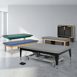 Physical therapist guiding a patient through rolling exercises on an extra-wide, electric hi-lo physical therapy mat table.