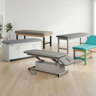 Physical therapist performing manual therapy on a patient using an adjustable electric hi-lo physical therapy table.