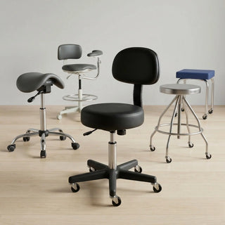 Physical therapist sitting on a low-height, ergonomic rolling saddle stool while assisting a patient in a rehab clinic.