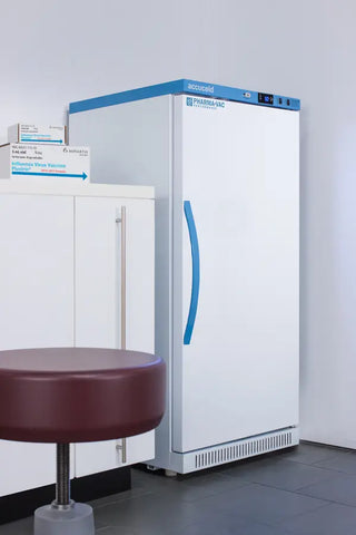 White Accucold ARS8PV456 8 Cu.Ft. Upright Vaccine Refrigerator with blue accents in a room with a red stool.