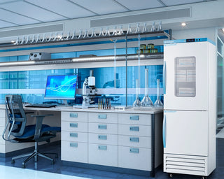 Modern laboratory setup with computer, microscope, and refrigerator.