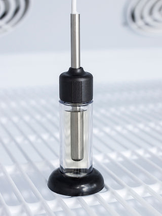 Clear electronic component with black and silver parts on a metallic surface