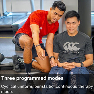 Trainer helping a seated user with Air Relax leg sleeves