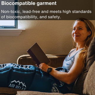 Woman reading on a couch while wearing Air Relax leg sleeves