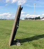 Bailey Manufacturing Model 28 Portable Sideline Mobile Athletic Treatment Table on a grass field with a clear sky