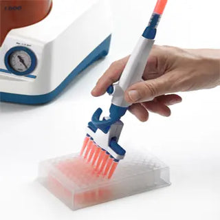 Hand holding a pipette with a Benchmark Scientific Accuris Aspire™ Laboratory Aspirator.