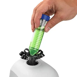 Hand holding a test tube with green liquid over a Benchmark Scientific BV1005 Mortexer™ Vortex Mixer.