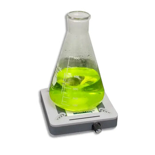 Erlenmeyer flask with green liquid on a Benchmark Scientific S1005 MiniMag™ Magnetic Stirrer against a white background