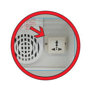 Showing electrical plug inside Benchmark Scientific myTemp™ Mini Digital Incubator with a red arrow pointing to it on a white background