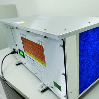 Industrial machine with a blue panel and warning label on a white background