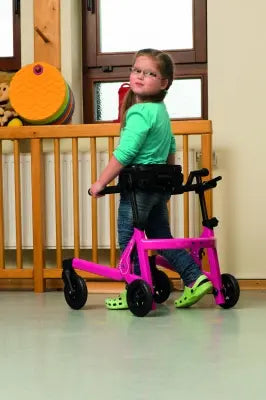 Child using a pink and black Clarke Healthcare Malte Posterior Size 0 to 4 Walker for Children in a home setting