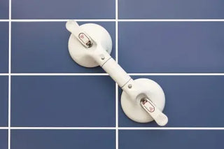 White Clarke Healthcare R1400220S Mobeli One Hand Grip Portable Grab Bar at Fixed Length with a bar on a blue tiled wall