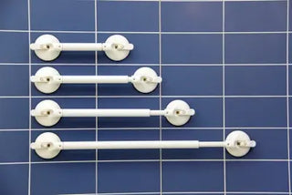 Set of white Clarke Healthcare R140022XS Mobeli Telescoping Shower Grab Bars on a blue tiled wall