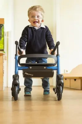 Child using a Clarke Healthcare S760XXXX Marcy Telescoping Rollator for Pediatrics indoors
