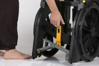 Person adjusting a Clarke Healthcare ZMR300100 WheelAble Commode and Shower Chair with a white background