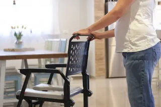 Person using a Clarke Healthcare ZMR400100241 BathMobile Folding Shower Chair lifter in a home setting