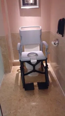 Bathroom with a Clarke Healthcare ZMR400100241 BathMobile Folding Shower Chair against a wall.
