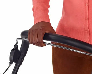 Person holding a black and silver scooter handlebar with a white background