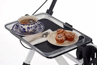 Portable tray with tea and pastries on a white background