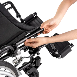 Close-up of a person adjusting the handle of a black Dynarex 10280 DynaRide S5 Ultra Lite Wheelchair.