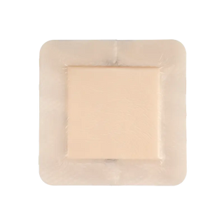 Rectangular piece of beige Dynarex 3059 Dürma+ SiliGentle Silicone Bordered Foam Dressings  in a clear plastic packaging on a white background
