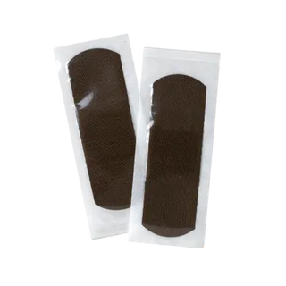 Two brown Dynarex 3635 ColorFit Adhesive Fabric Bandages Flexible Fabric Absorbent Pad patches in clear packaging on a white background