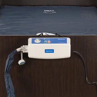 Dynarex medical device attached to a bed with blue mattress