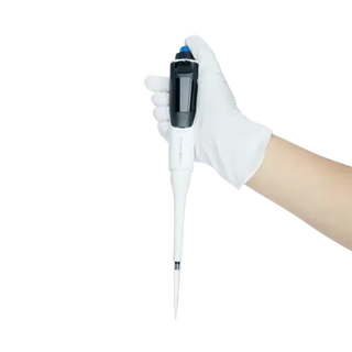 Hand wearing a white glove holding a black and white Dynarex Electronic Pipette 40101 on a white background