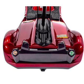 Close-up of a red and black vehicle with visible branding on a white background