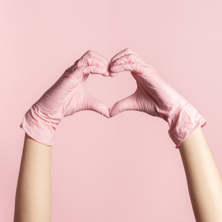 Hands in Eco Gloves SoftTouch BLUSH Nitrile Gloves forming a heart shape