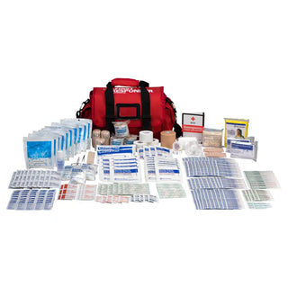First aid kit with various supplies on a white background