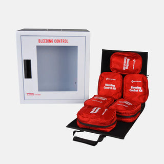 Red bleeding control kits on a black tray with a white cabinet labeled 'Bleeding Control' in the background.