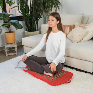 Woman sitting cross-legged on the HealthyLine Amethyst Legacy 3618 mat on a rug