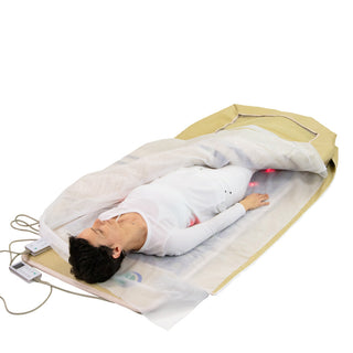 Woman lying in a HealthyLine envelope cover inside a 360 Wrap mat