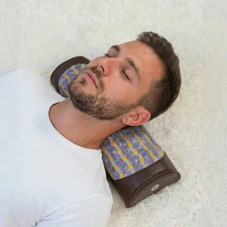 Man resting his neck on the HealthyLine Amethyst Bolster