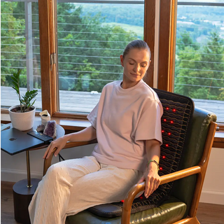 Woman seated on the HealthyLine Jet Chair mat by a window