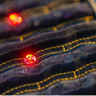 Close view of a lit red LED between the stone rows of the Jet mat