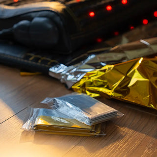 Packaged HealthyLine mylar blankets beside a heating mat