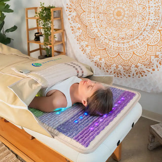 Person on a massage table inside the HealthyLine Rainbow Chakra 360 Wrap Set