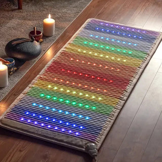 Lit HealthyLine Rainbow Chakra mat on a wooden floor