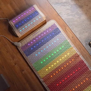 HealthyLine Rainbow Chakra mat and pillow on a wooden floor