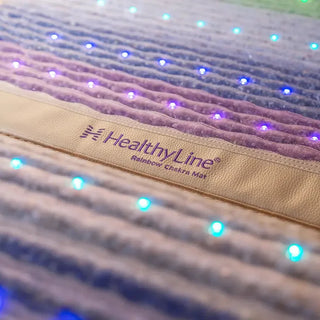 Close view of the HealthyLine logo and lights on the Rainbow Chakra mat