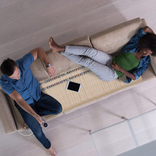 Two people on a sofa on the HealthyLine SOFT Pro mat