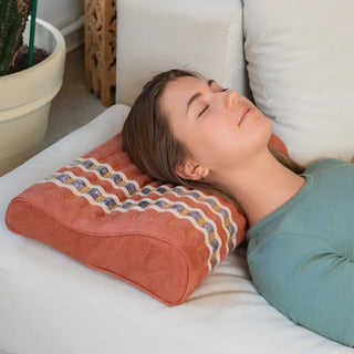 Woman resting her head on the HealthyLine TAO Pillow