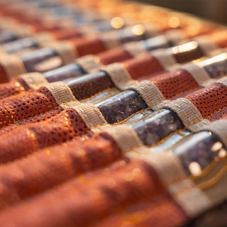 Close view of the tourmaline, amethyst and obsidian stones on the HealthyLine TAO mat